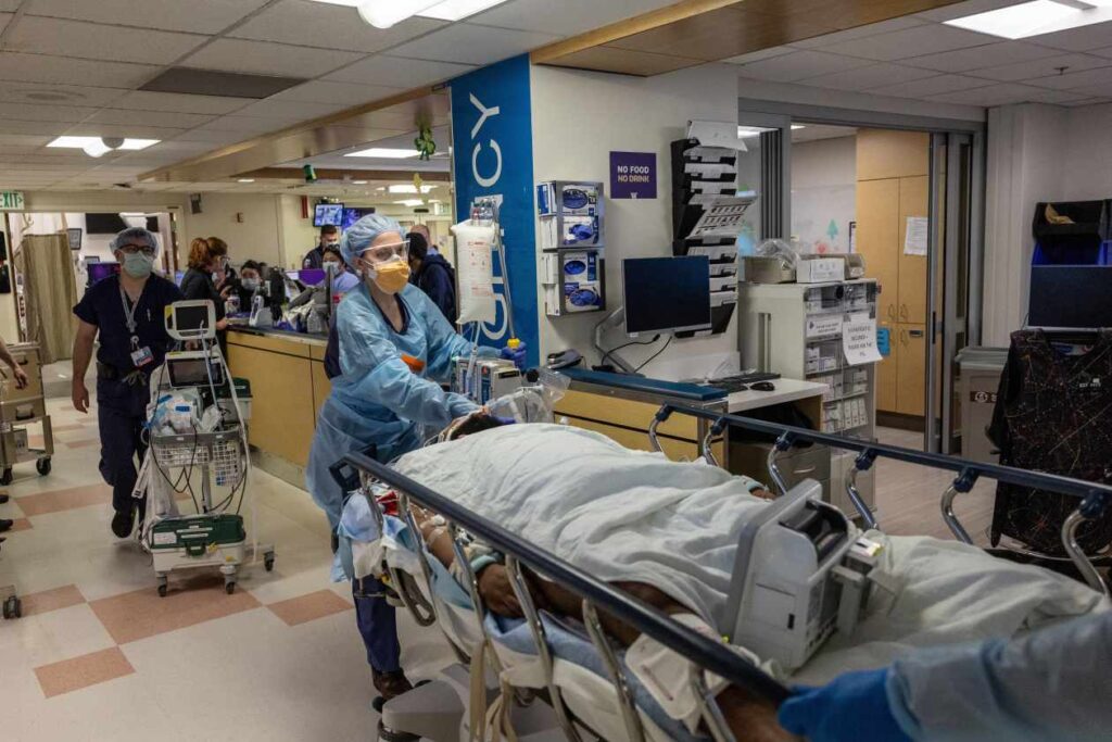 Healthcare worker wearing PPE transports